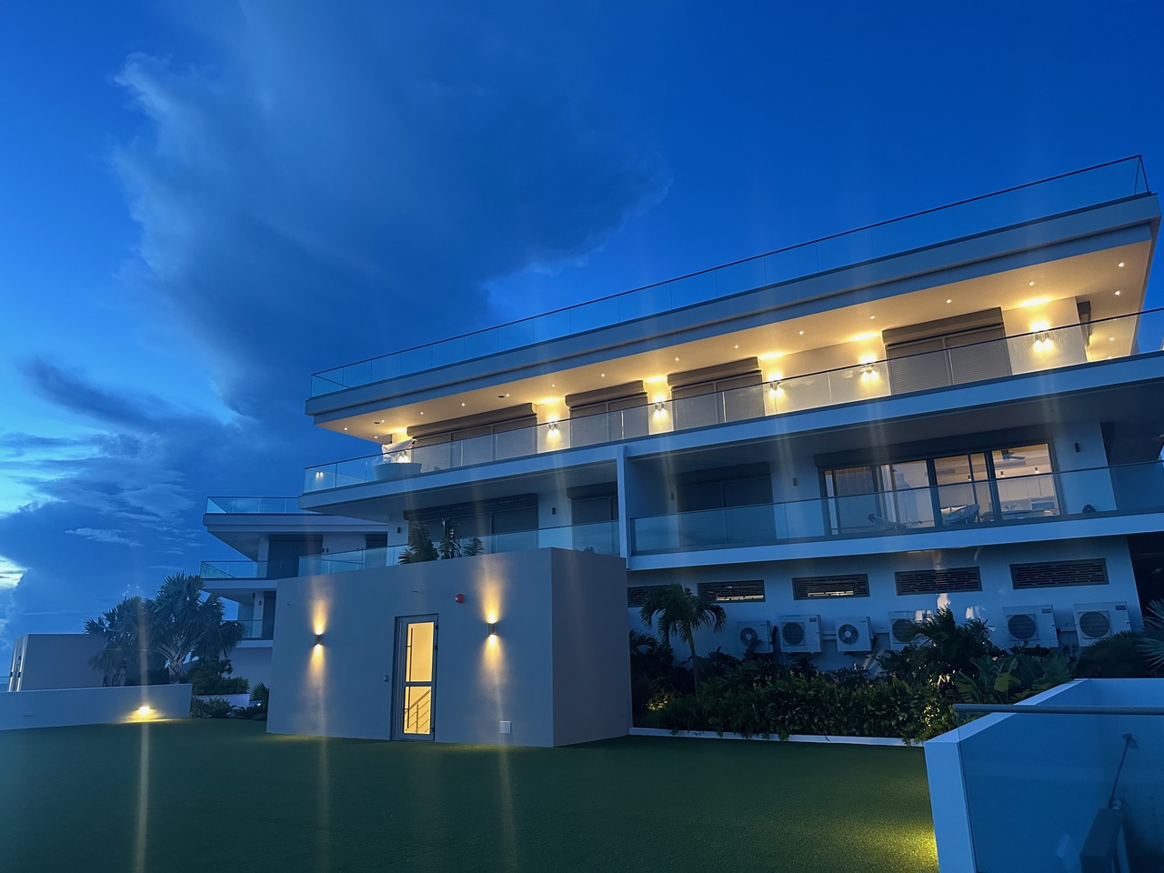 Panorama Residences exterior illuminated in the evening.